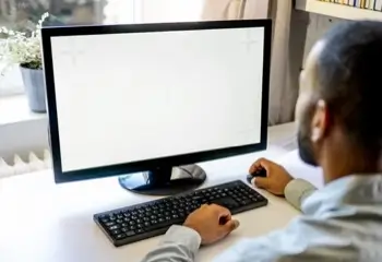 A man uses a personal computer, or PC